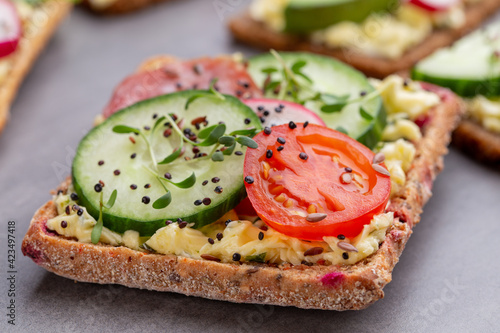 Sandwiches with cream cheese, vegetables and salami.