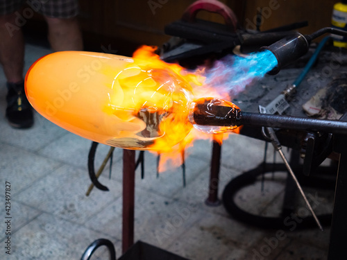 Artist glass blowing process. The glassblower master create