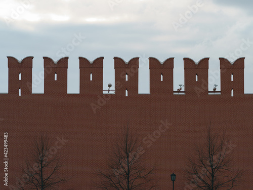 Red Kremlin wall at spring day time. Details of the beautiful medieval architecture in the Moscow downtown. Red square. Surveillance cameras everywhere