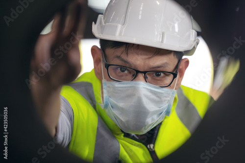 Engineers examine new coated pipe in factory, Ventory Check photo