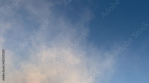 Abstract video with white smoke against the blue sky