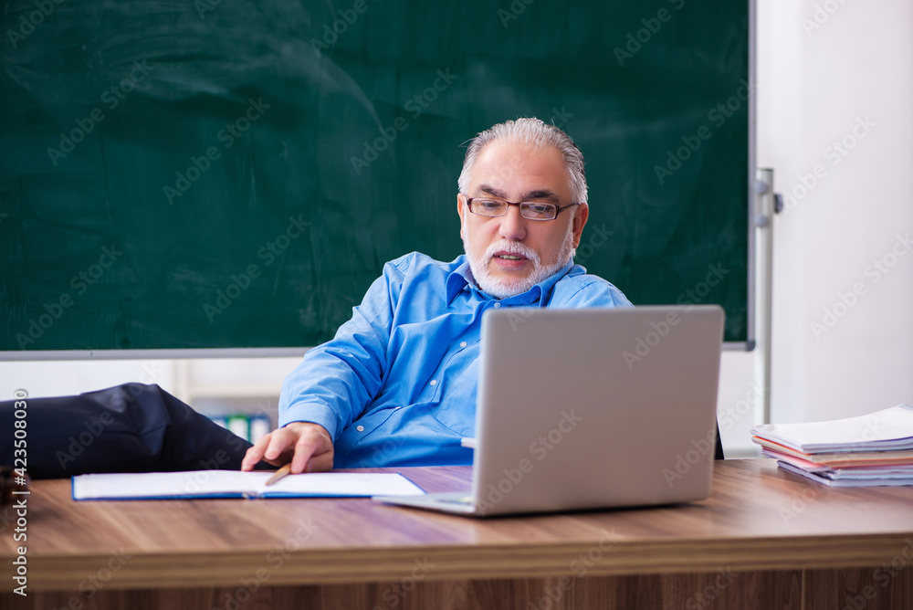 Old male teacher in tele-education concept Old male teacher in tele-education concept