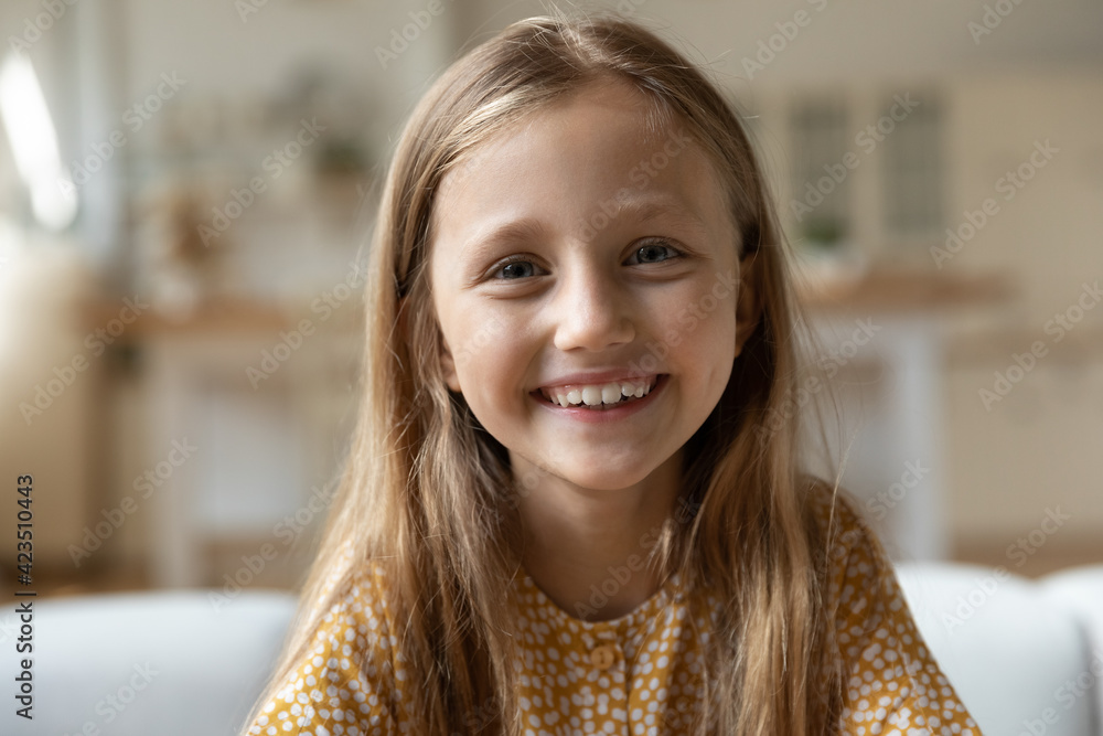 Close up headshot portrait of smiling little 8s Caucasian girl child look at camera talk on video call online. Profile screen view of happy kid have webcam digital conference. Virtual event concept. Close up headshot portrait of smiling little 8s Caucasian girl child look at camera talk on video call online. Profile screen view of happy kid have webcam digital conference. Virtual event concept.