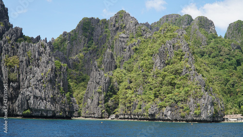 Green lush karst mountains rising out of the ocean on Palawan Island near El Nido, Philippines