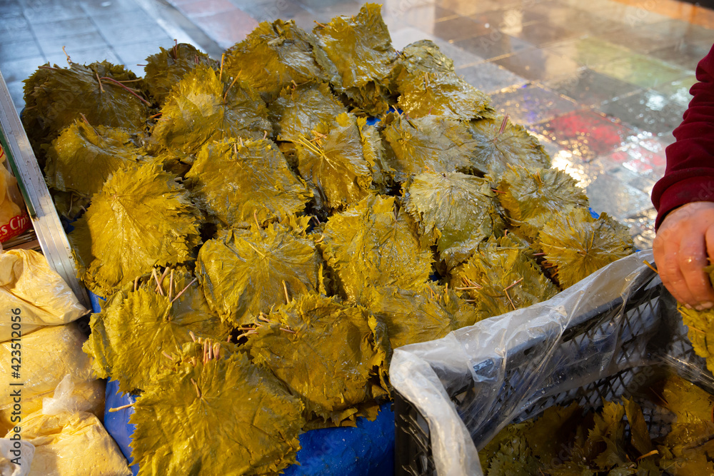 Top view, Pickled grape leaves standing on counter in market place
