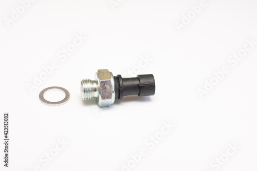 Car engine oil pressure sensor with O-ring. Isolated on a white background. Selective focus. 