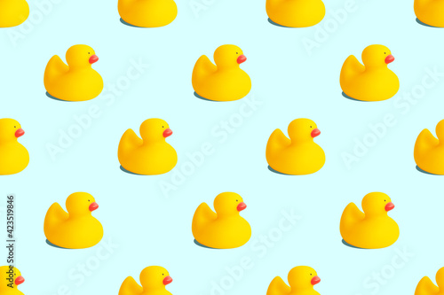 Yellow rubber duck toys seamless pattern isolated on pastel blue background. Opposition symbol and political struggle minimal concept