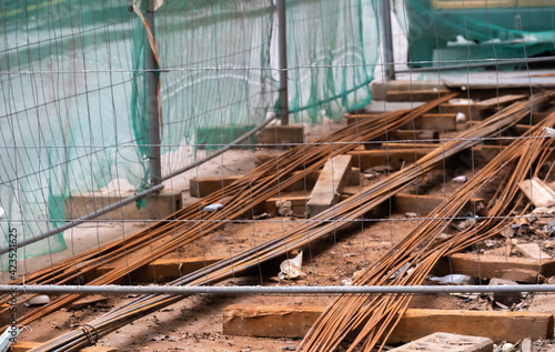 Wallpaper Mural industrial background, iron rusty metal rods for construction and repair, folded and fenced with a net Torontodigital.ca