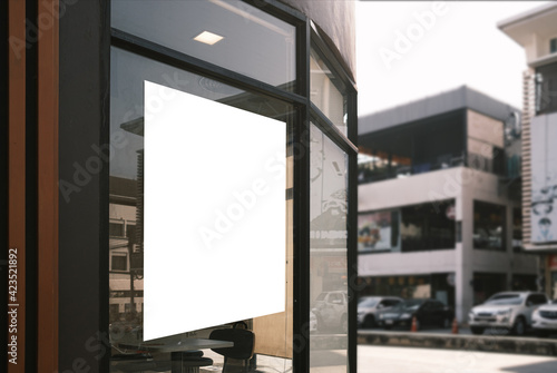 Mockup white poster or white paper promotion displayed on the front of the restaurant, coffee shop promotion information for marketing announcements and details