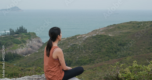 Woman sit at the top of the mountain