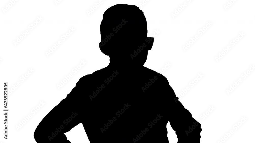 Silhouette Cool young boy in a leather jacket putting on black glasses with arms on his hips. Silhouette Cool young boy in a leather jacket putting on black glasses with arms on his hips.