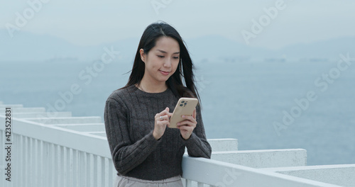 Woman use of mobile phone at outdoor © leungchopan