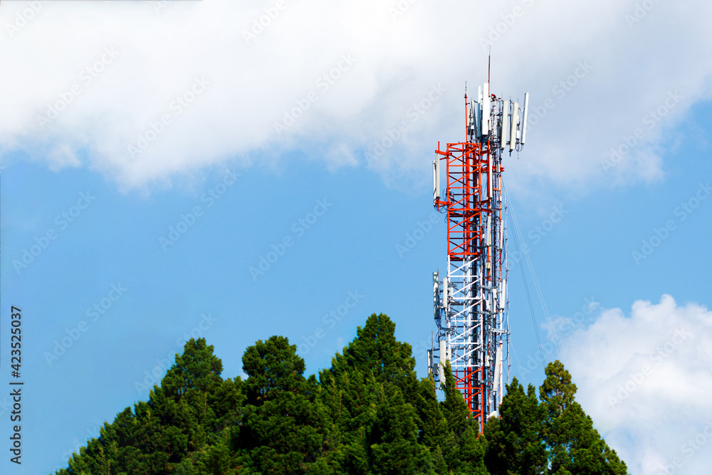 Communication transmitter tower with antenna on blue sky background