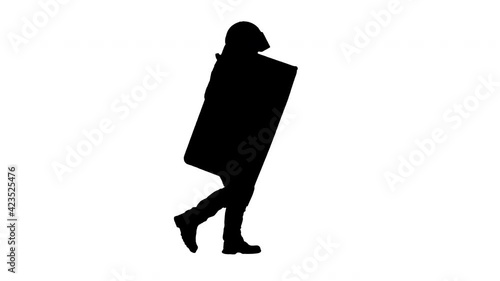 Silhouette Policeman in full uniform running with a shield and baton. photo