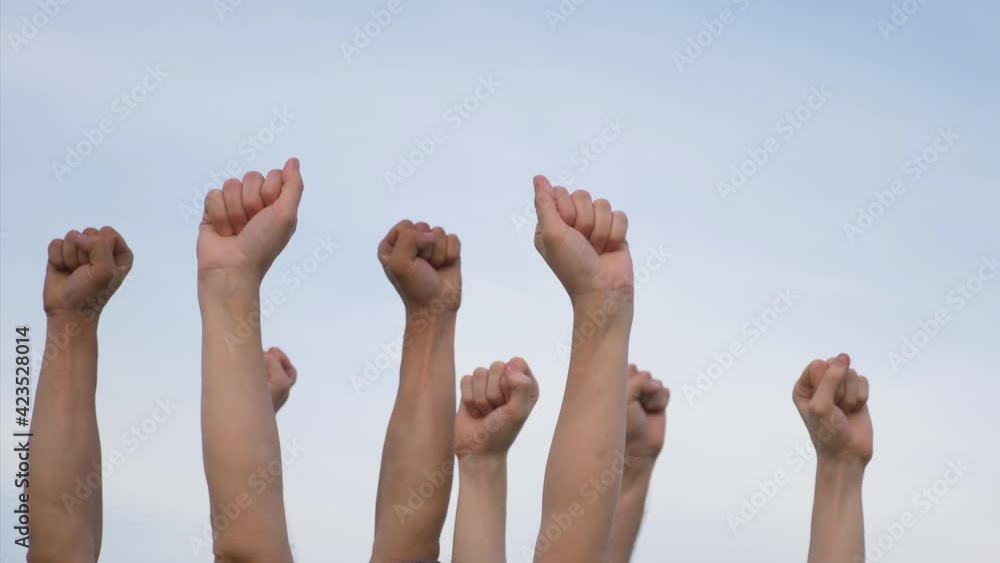 Teamwork. A group of people against the sky raises their hands up. The concept of voluntary voting, expression of consent, support for democracy. Teamwork. A group of people against the sky raises their hands up. The concept of voluntary voting, expression of consent, support for democracy.