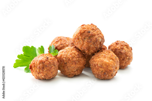 Foto Fried meatballs with a parsley leaf isolated