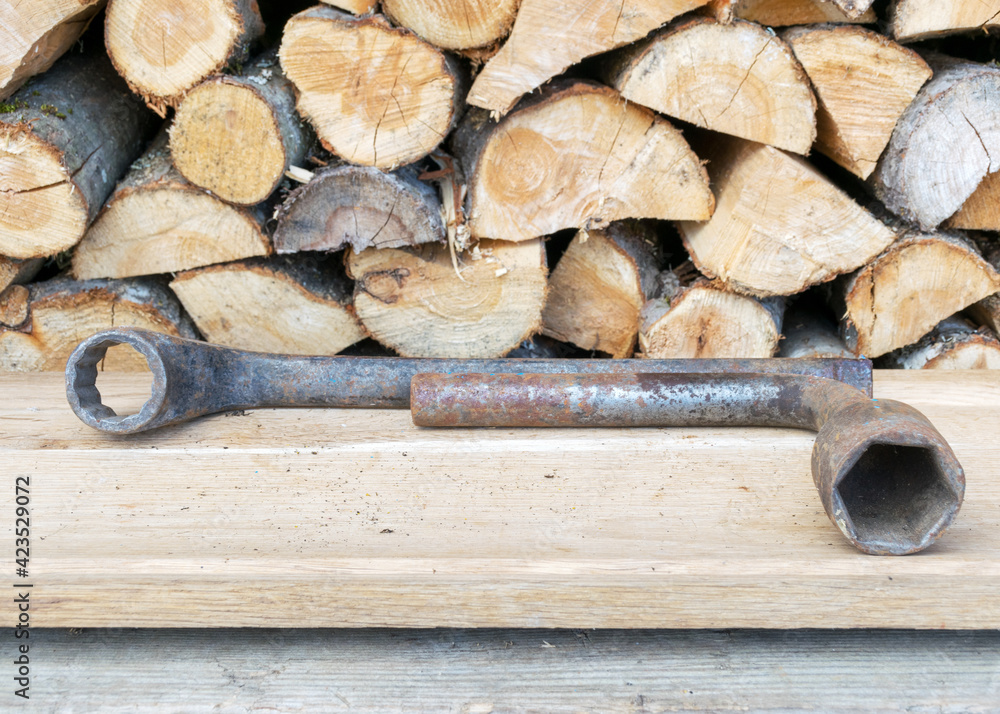 Antique wrenches on a wooden background, rusty tools, metal waste, scrap metal Antique wrenches on a wooden background, rusty tools, metal waste, scrap metal