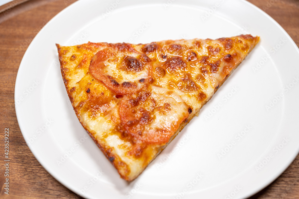 Thinly sliced pepperoni is a popular pizza Thinly sliced pepperoni is a popular pizza