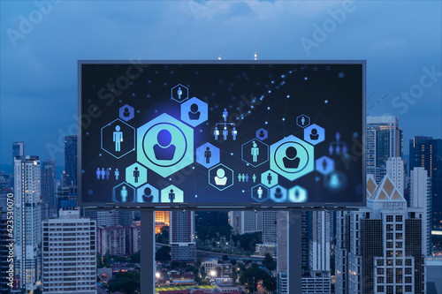 Glowing Social media icons on billboard over night panoramic city view of Kuala Lumpur  Malaysia  Asia. The concept of networking and establishing new connections between people and businesses in KL