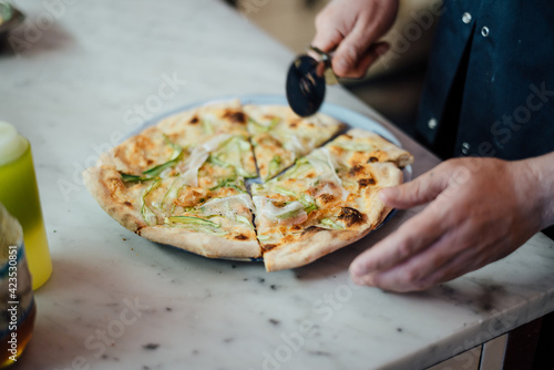 Chef cutting pizza