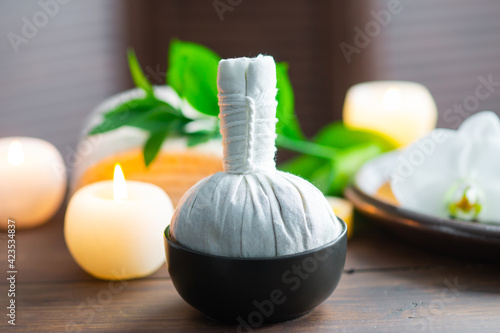 Spa background. Towel  candles  orchid flowers and herbal balls. Massage  oriental therapy  wellbeing and meditation.