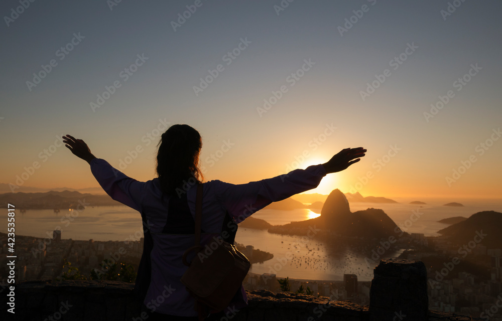 silhouette of a person with arms raised in Rio de Janeiro, Brazil