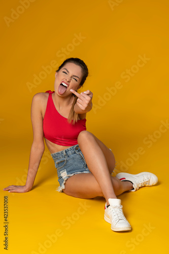 Fotografie attractive model in shorts and swimsuit fucking you off