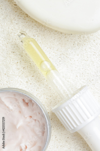 Nourishing and hydrating facial serum, antirid cream and facial sponge, close up image. 