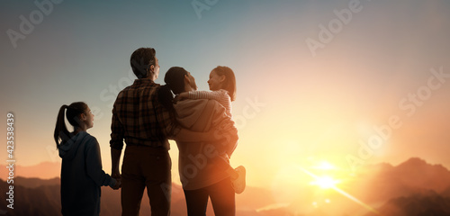 Happy family at sunset. photo