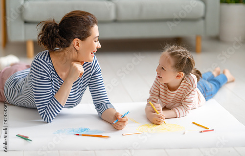 Mother and daughter are drawing