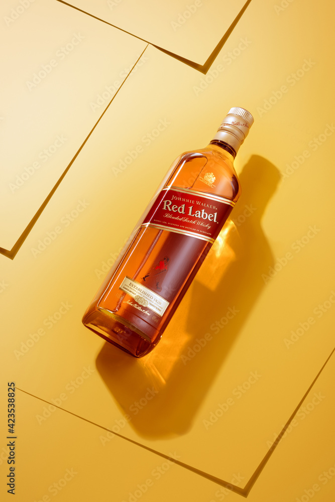 Phuket, Thailand- Jan 2021. Johnnie Walker Red Label blended whisky  isolated on color background. Johnnie Walker is the most widely distributed  brand of blended Scotch whisky in the world. Stock Photo