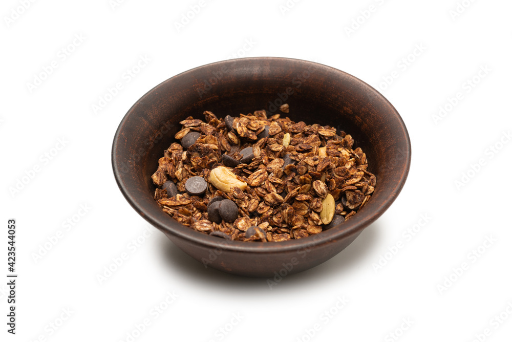 Chocolate granola cereal with nuts in a bowl background. Chocolate granola cereal with nuts in a bowl background.
