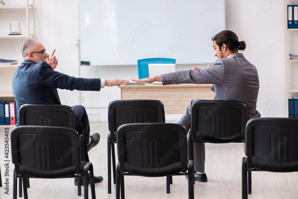 Two businessmen in the classroom in pandemic concept Two businessmen in the classroom in pandemic concept