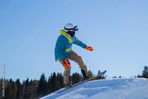 A snowboarder on a snowboard. Extreme winter sports.Rest in winter.