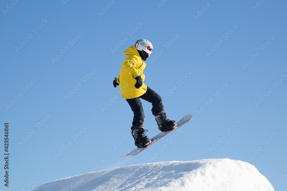 A snowboarder on a snowboard. Extreme winter sports.Rest in winter. A snowboarder on a snowboard. Extreme winter sports.Rest in winter.