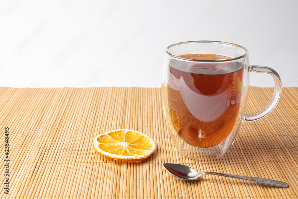 glass thermo mug with black tea on the table glass thermo mug with black tea on the table