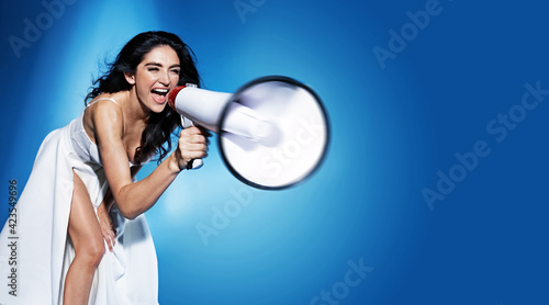 Elegant woman yelling with a bullhorn - communication concept