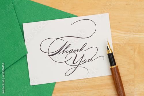 Thank You greeting card in green envelop with pen