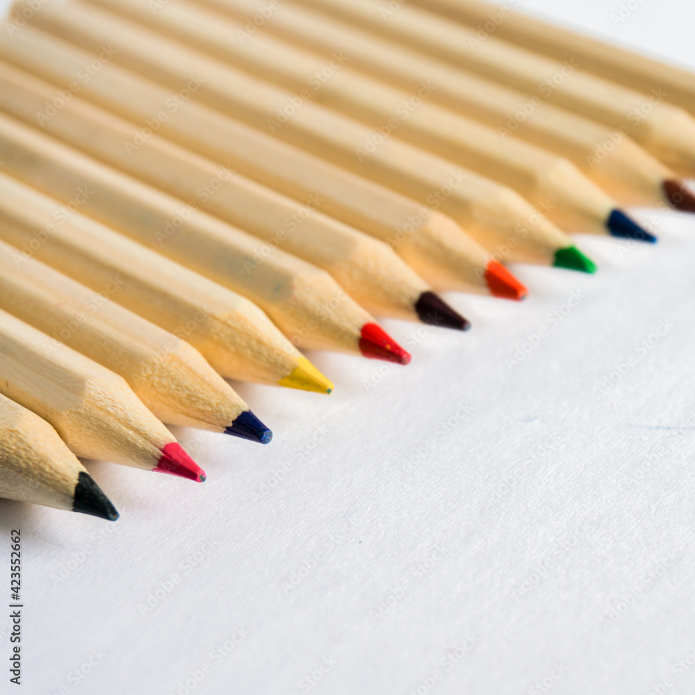 Obraz premium Kid Art education concept. Color pencils on white paper background. copy space