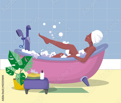 The girl in the bathroom. A girl with a towel on her head takes a pink foam bath. Layout, design element.
