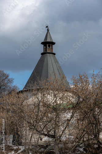 old white stone monastery with golden domes on a sunny spring day against the background of the sky and clouds 