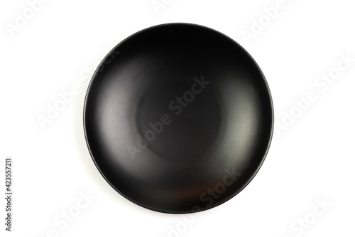 Black empty plate isolated on white background, Top view. Plate made of ceramic. Exquisite tableware.