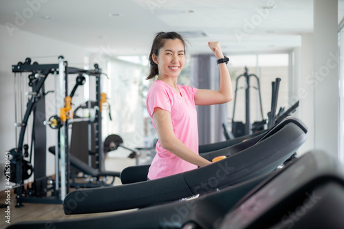 Asian women are exercising in the gym to sift through the leather water, keeping their body healthy. Premium Photo