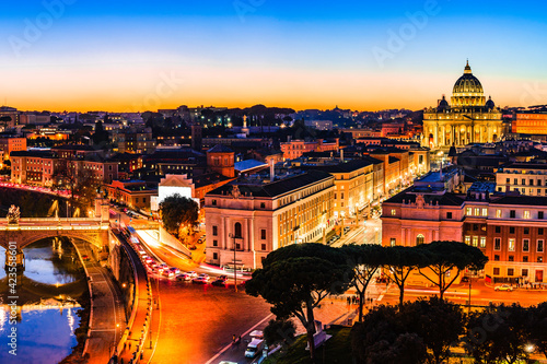 Night view of St. Peter's Basilica and the Tiber river in Vatican City, Rome, Italy