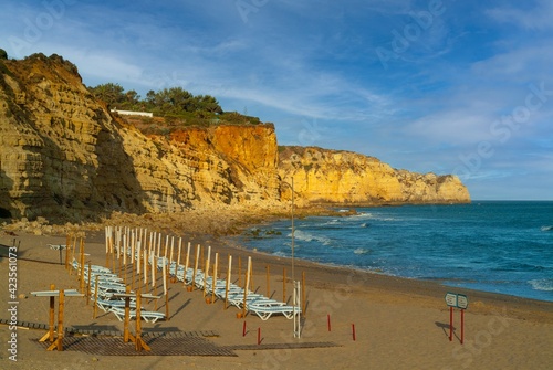 Sandstone Rocks and cliff at Salema beach, Portugal photo