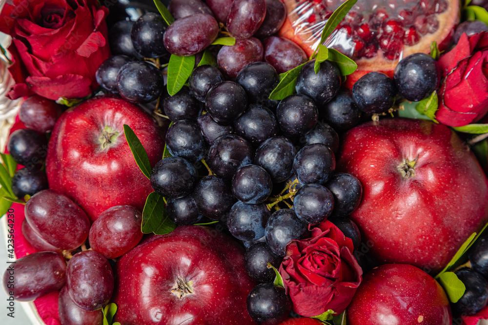 Juicy, fresh fruits, dark grapes and red apples, beautifully presented. Close-up Juicy, fresh fruits, dark grapes and red apples, beautifully presented. Close-up