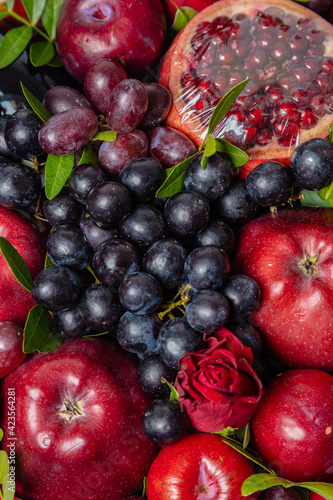 Fototapeta Naklejka Na Ścianę i Meble -  Juicy, fresh fruits, dark grapes and red apples, beautifully presented. Close-up