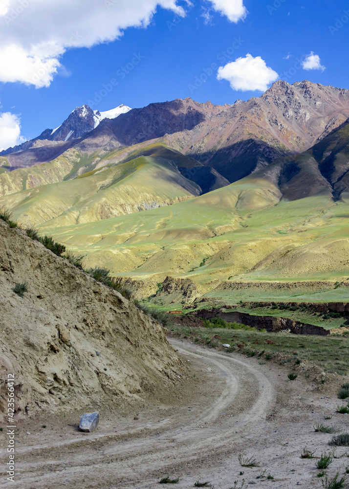 Sharp turn of the dirt road into a narrow mountain valley. Sharp turn of the dirt road into a narrow mountain valley.
