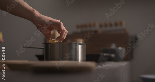 man hand put fettuccine pasta in saucepan with boiling water closeup © GCapture