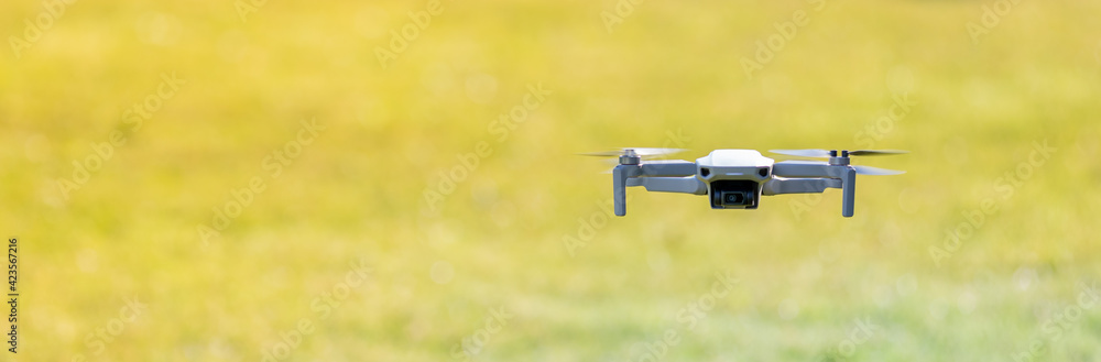 A drone flying outdoor, zoom photo, technology theme A drone flying outdoor, zoom photo, technology theme